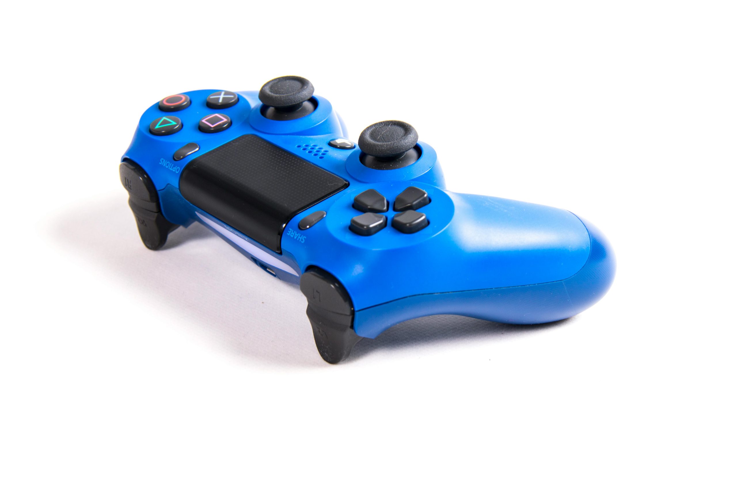 Close-up of a blue wireless game controller on white background. Perfect for gaming and technology themes.